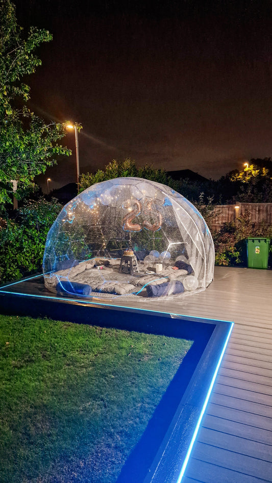 A GeoDomeX dome on decking lit up at night